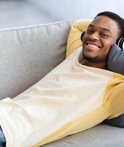 black-guy-in-wireless-headset-resting-on-couch-at-2025-03-18-17-43-39-utc.jpg